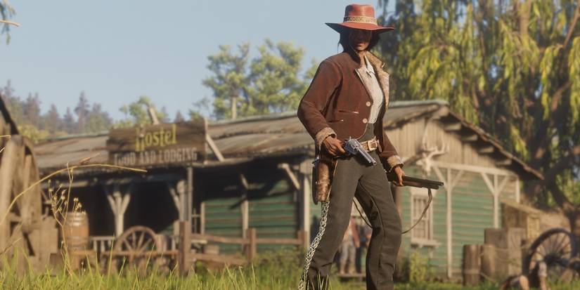 Red Dead Online posing with a revolver and shotgun