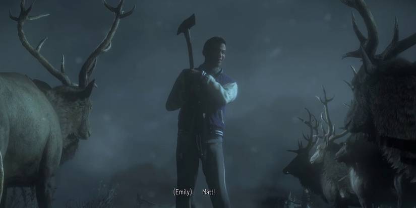 Matt holding axe while surrounded by reindeer.