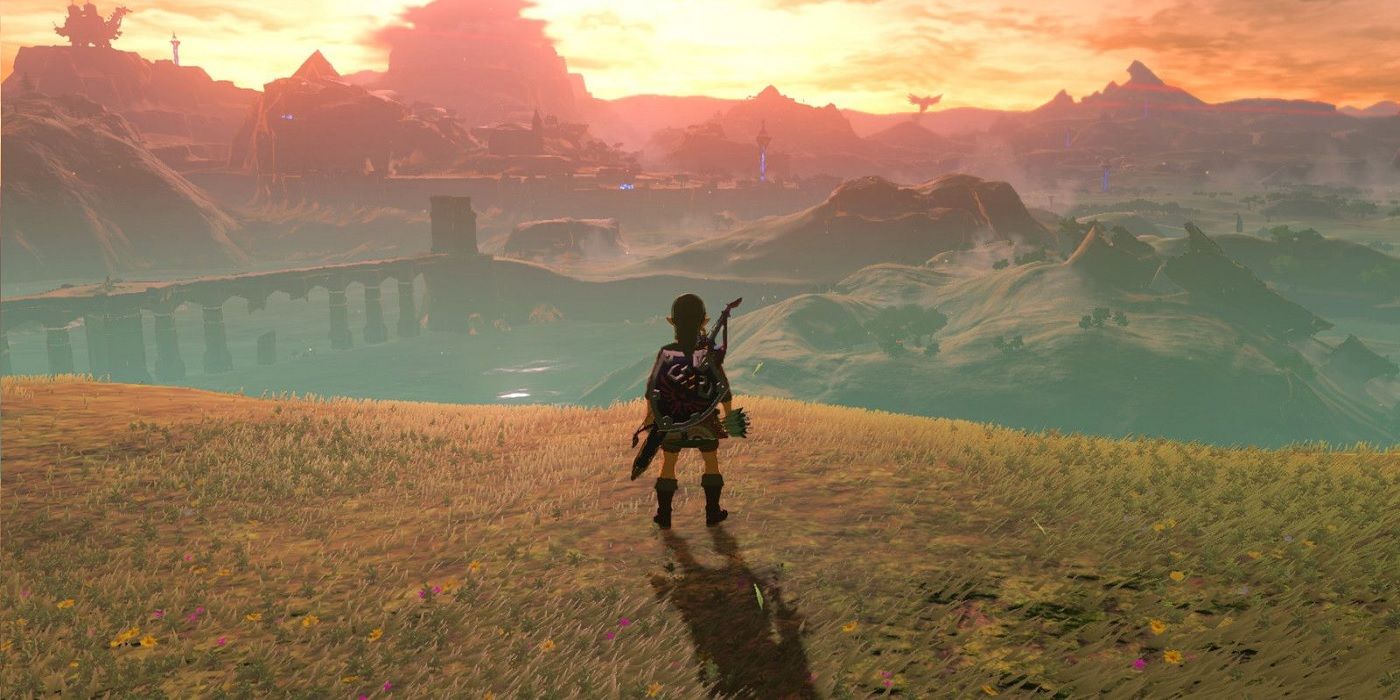 Link staring at sunset and bridge in horizon in Zelda breath of the wild