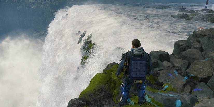 sam standing at edge of waterfall