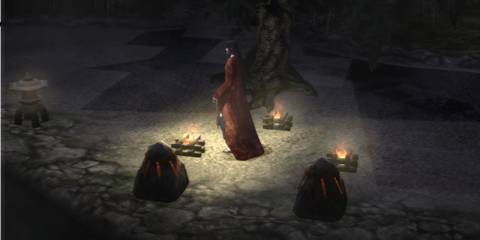 woman walking through lit path at night