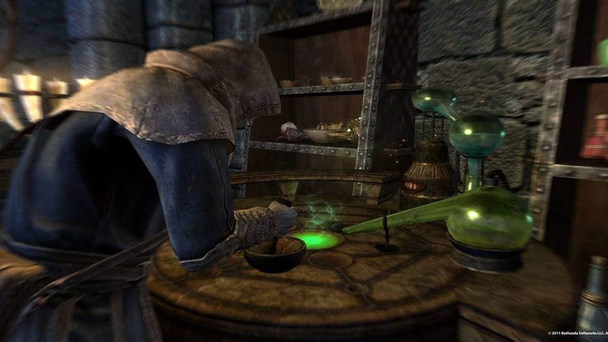 Skyrim character performing alchemy