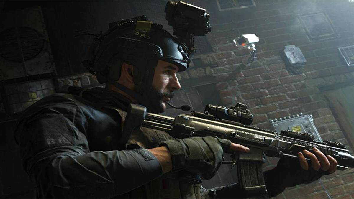 Captain Price holding a gun outside a brick building at night.