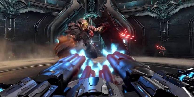 Doom Eternal firing chaingun at large monster in circular arena