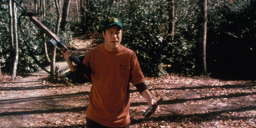 Man in the woods holding a rifle and beer