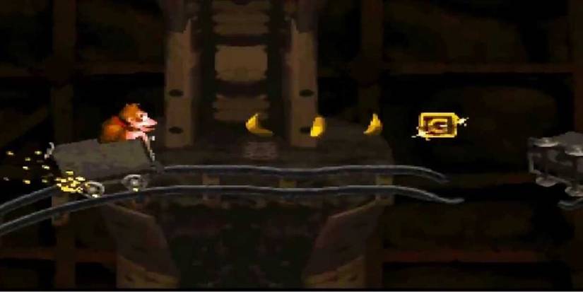 Donkey Kong on mine cart apporaching bananas in Donkey Kong Country for Super Nintendo