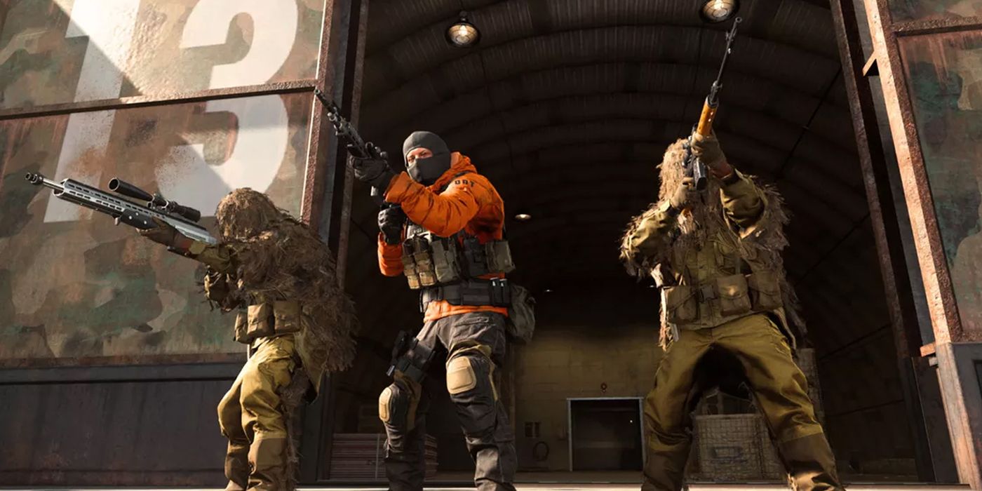 three operators standing outside a bunker