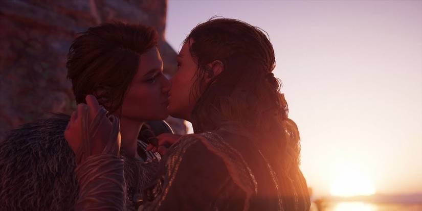 Kyra and Kassandra kissing with a beautiful sunset in the background