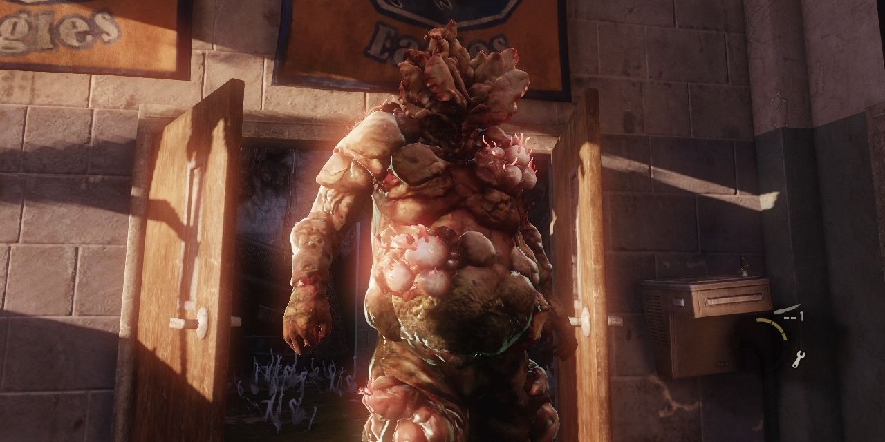 A Bloater stands in a school hallway in The Last of Us
