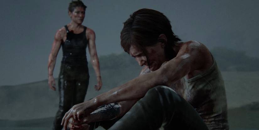 Abby looks on as Ellie breaks down crying in The Last of Us Part II