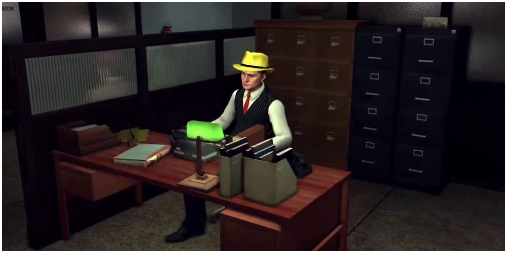 Cole Phelps sitting at his desk