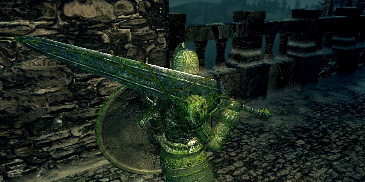 player in stone knight armor wielding the stone greatsword in dark souls urban area