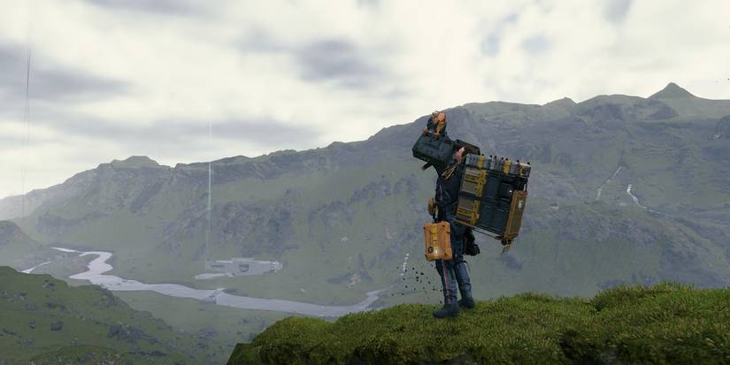 death stranding sam holding bb above his head on cliff