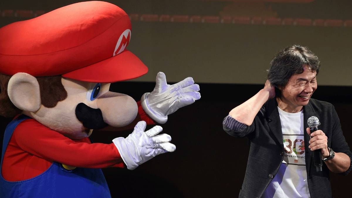 nintendo mario suit and shigeru miyamoto on stage