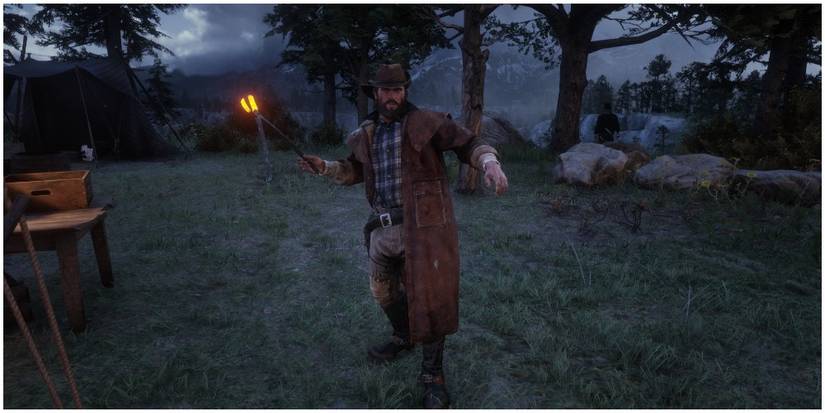 Bill holding a pair of hot tongs in camp