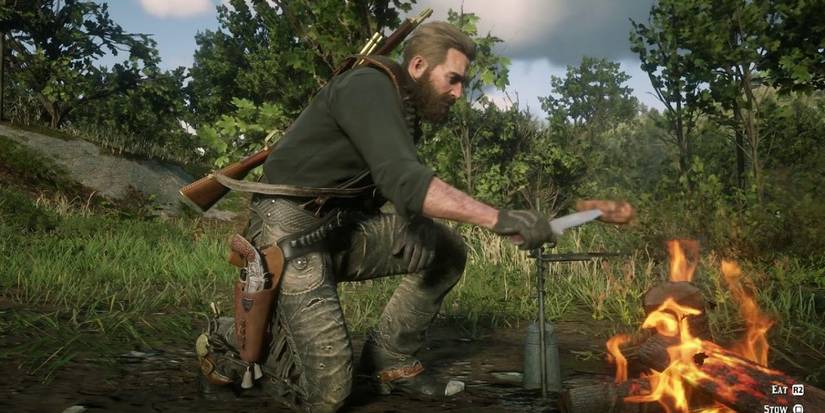 Arthur Morgan cooking food at his camp