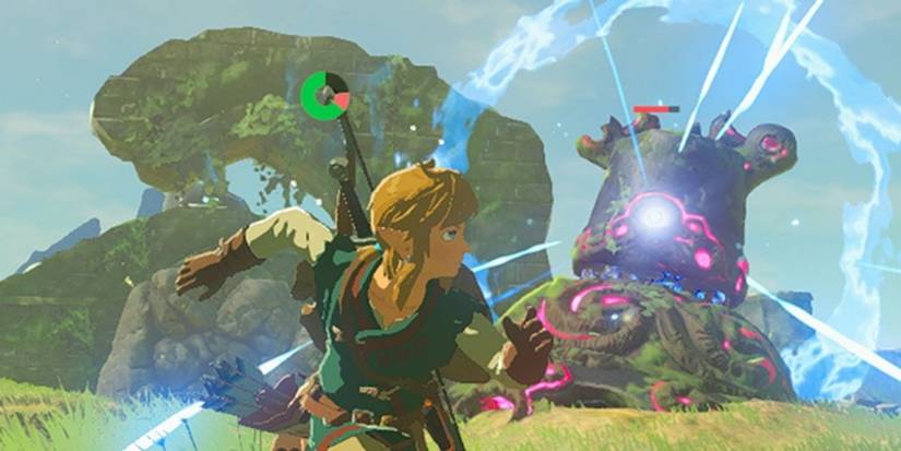 A guardian takes aim at Link as he runs away in Breath of the Wild