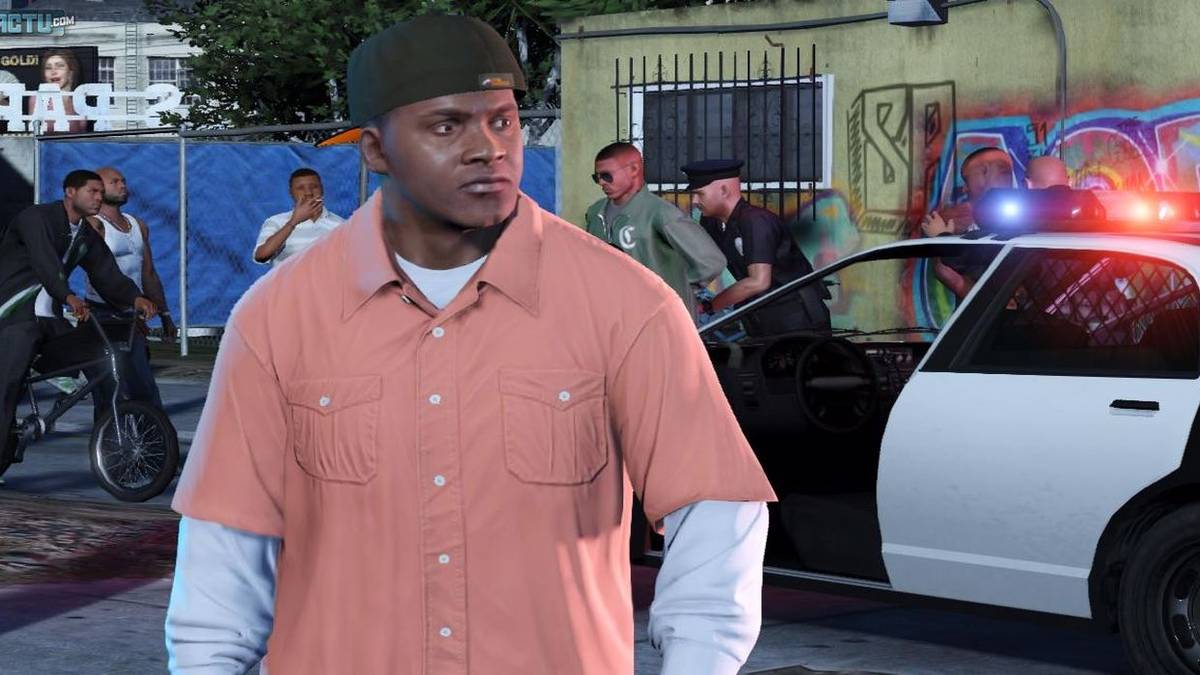 franklin in hat and pink shirt with cop car in background