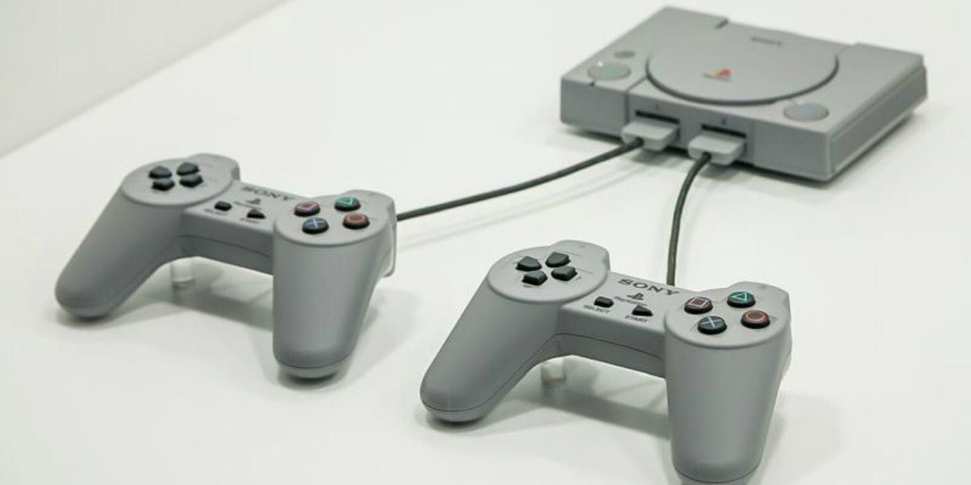 The Playstation 1 with two controllers.