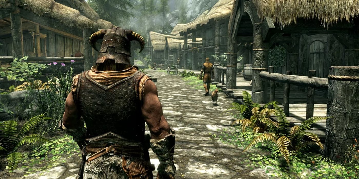 Skyrim town with huts and growth over shoulder of horned masked hero