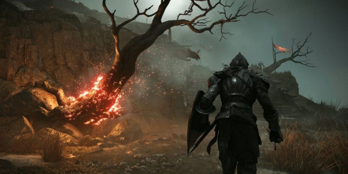 Demon's Souls player walking past burning tree