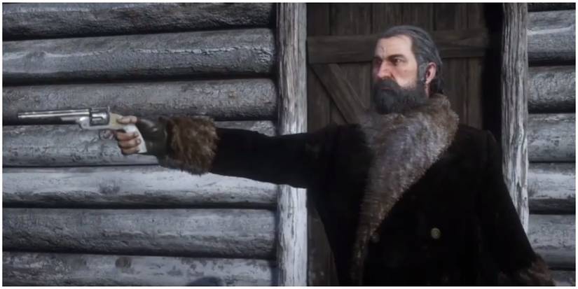 Dutch aiming his gun at Micah right before shooting