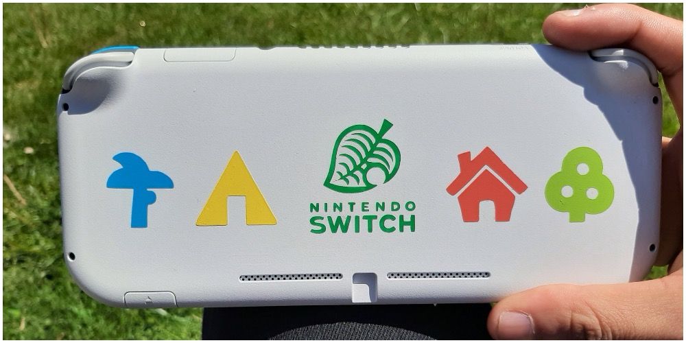 A Switch with animal crossing symbols on it