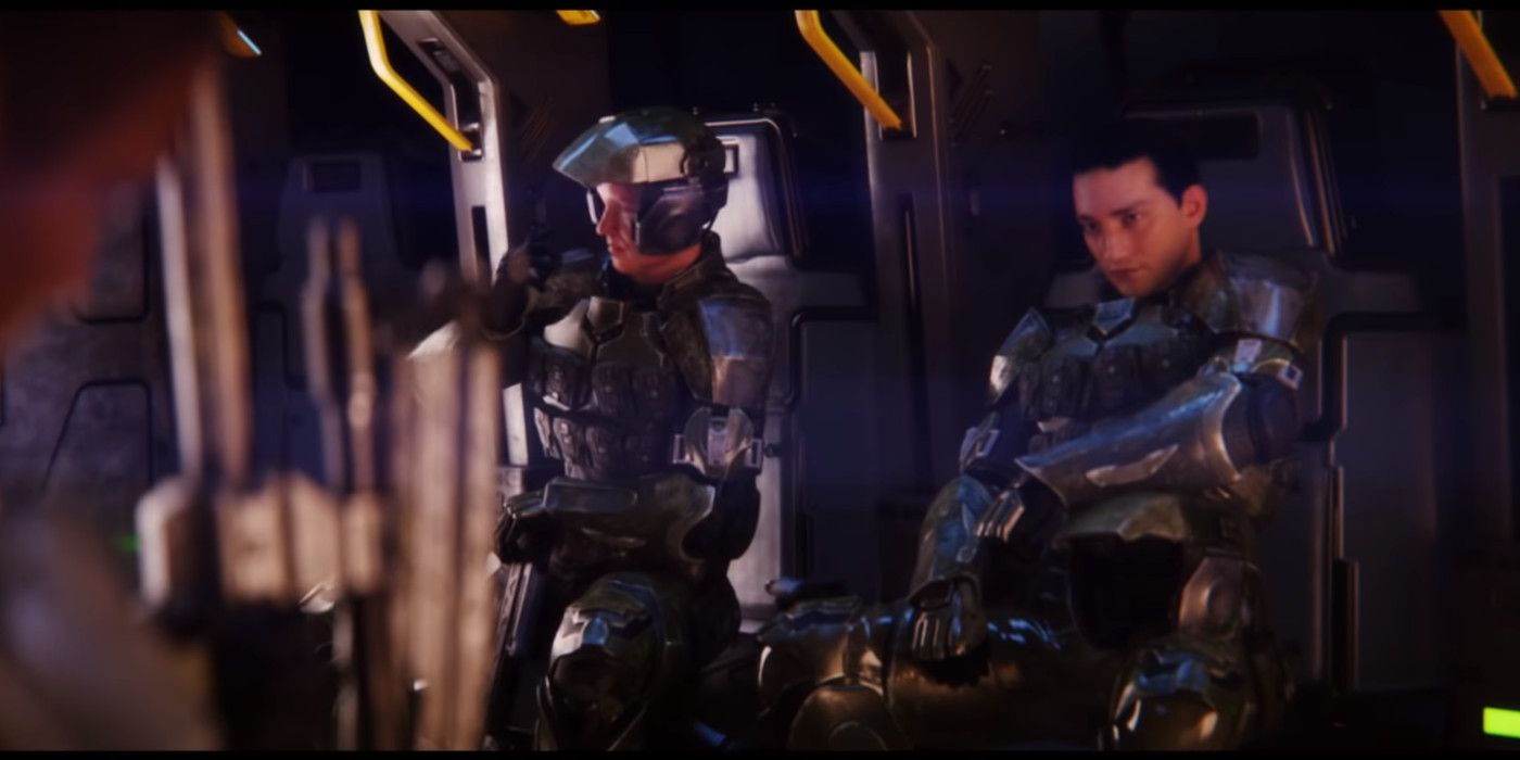 Two marines in Halo Master Chief Edition wait to exit the drop ship. One is wearing headgear resembling headphones.