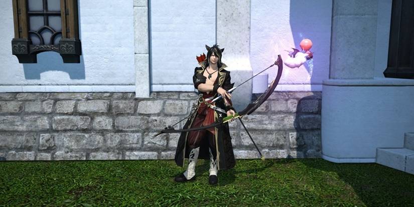 Miqo'te holding moogle-themed bow outside.