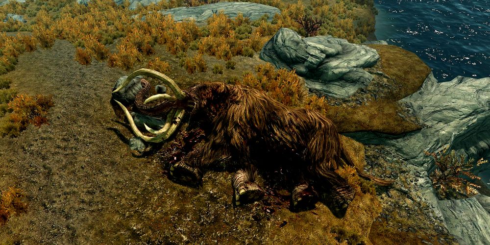 a dead mammoth lying on the grass