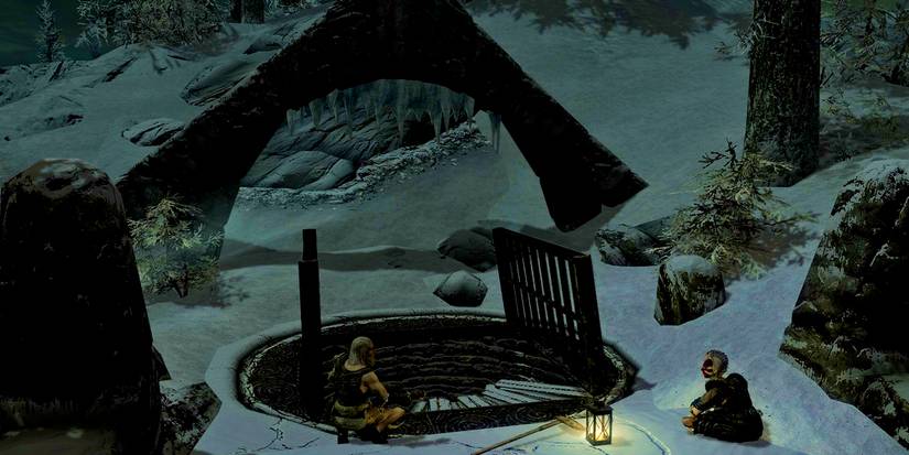 two bandits sitting outside of a stairwell leading down at night