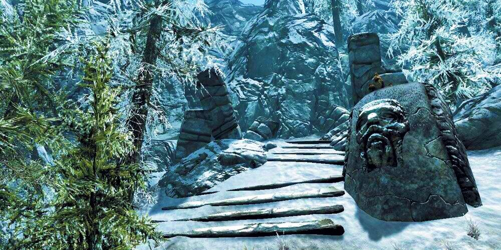 snowy stairs and a carved stone face in the north of skyrim