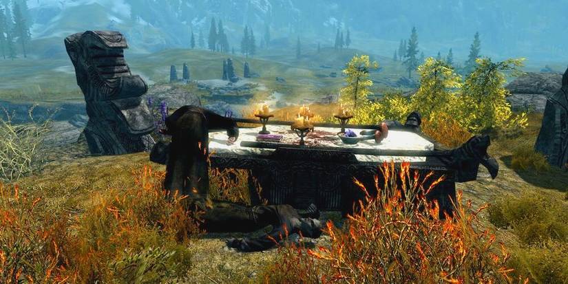 necromancer altar with two dead mages in a field