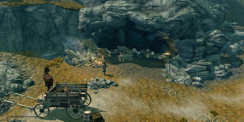 an alcove full of crates with a horse and wagon nearby