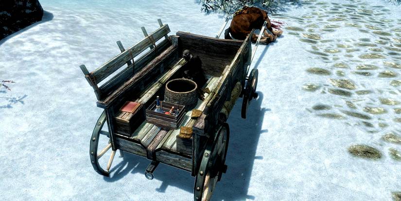 wagon with a dead horse that was attack by bandits by the road