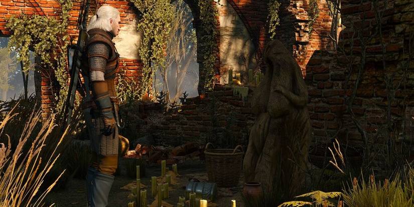 Geralt standing in a small shrine to a false god