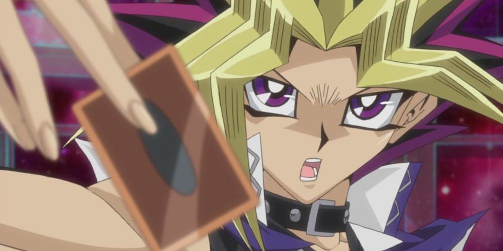 Yami Yugi holding a card in the Yu-Gi-Oh! anime
