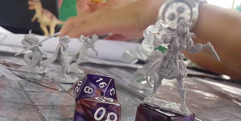 A miniature on top of dice