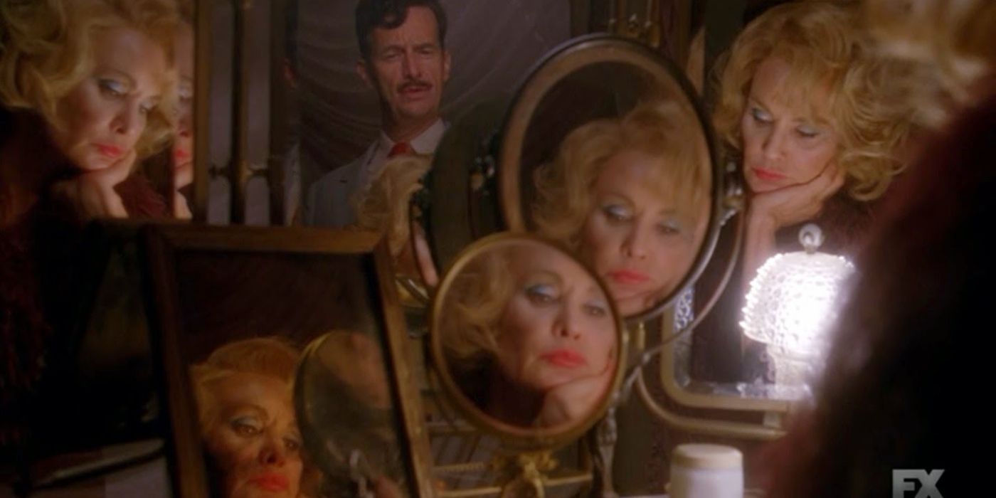 Screen still from American Horror Story showing Jessica Lange's face reflected in numerous mirrors