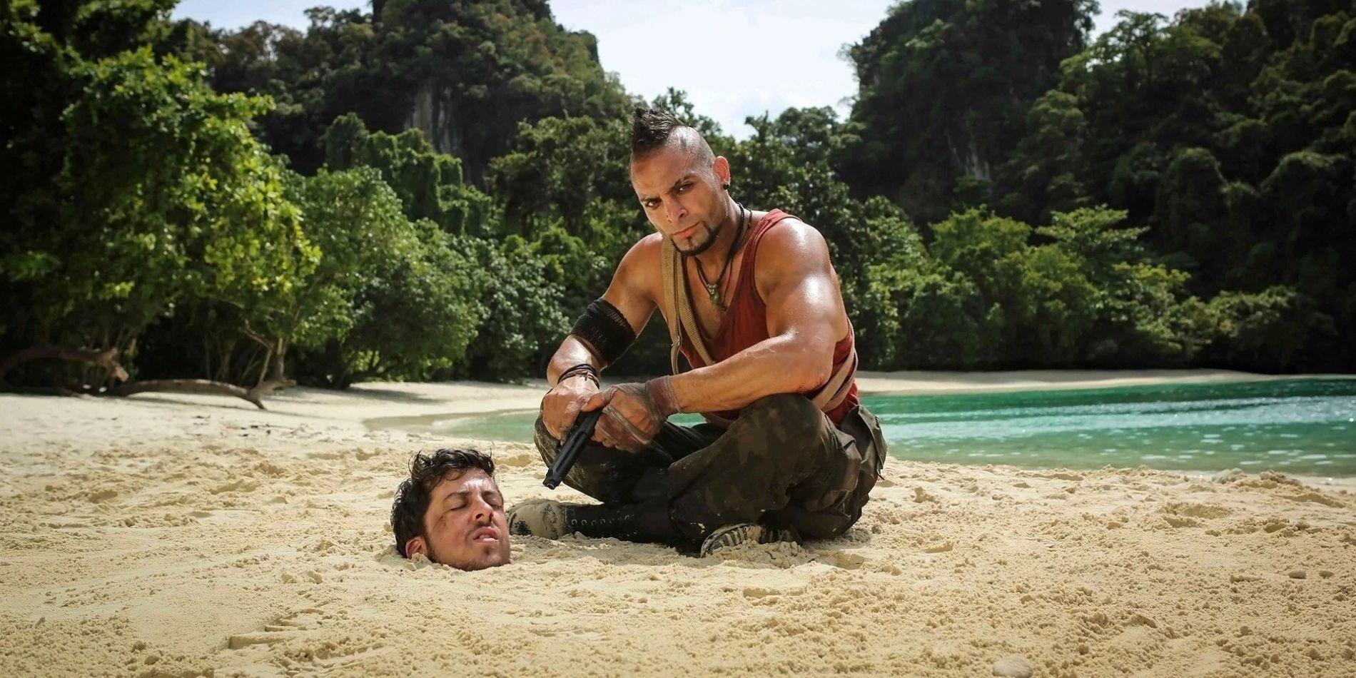 Vaas Montenegro, played by Michael Mando, sits on a beach with Christopher Mintz-Plasse buried up to his chin in the sand
