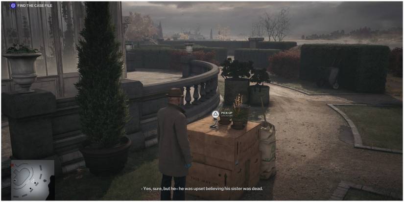 Agent 47 Picking up a crowbar in Hitman 3