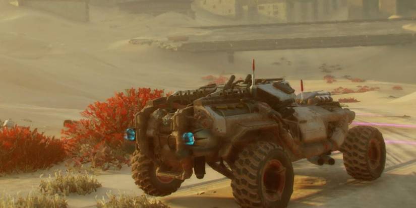 a car driving with a buliding in the background