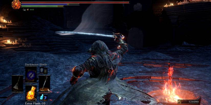 player holding the sabre above their heads by a bonfire.