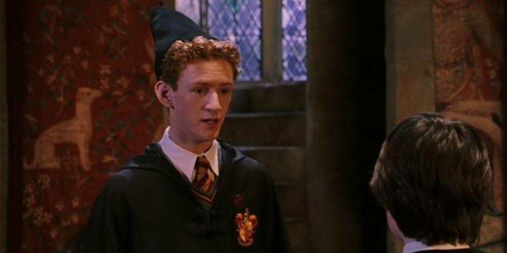 Percy Weasley talking to Harry Potter
