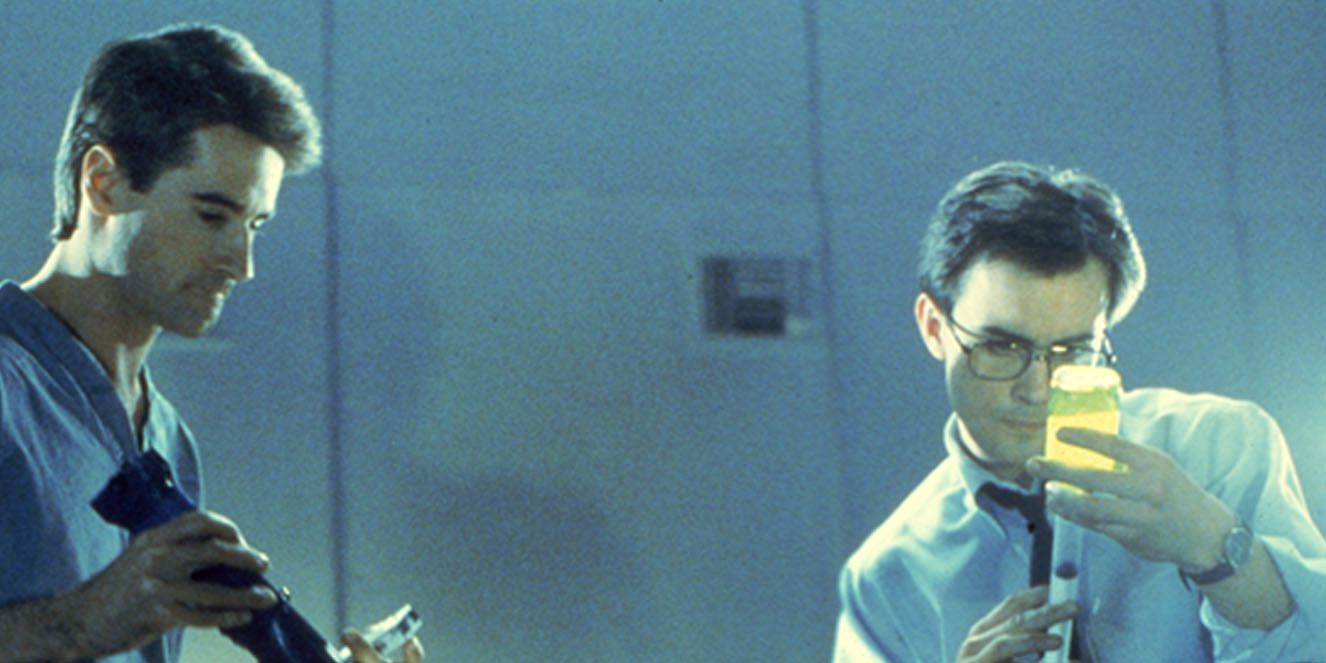 Two characters working with vials and syringes in Re-Animator (1985)