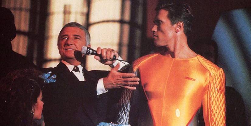 Arnold Schwarzenegger in The Running Man in jumpsuit staring at game show host