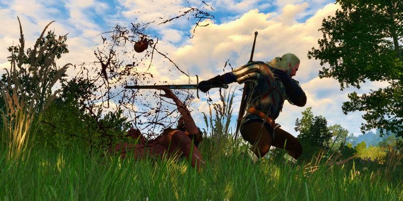 geralt cutting a bandit's dead off with his steel sword
