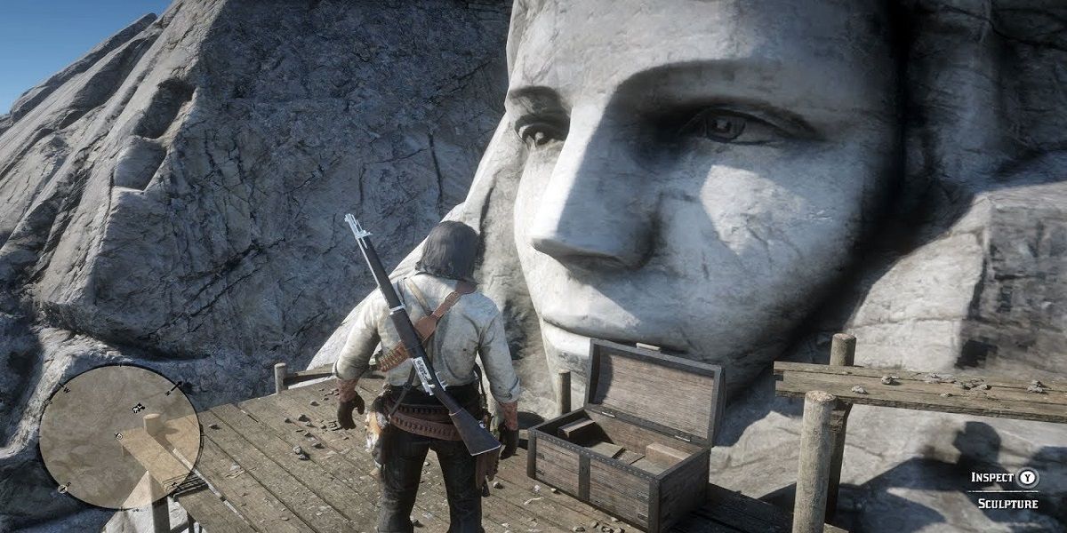 RDR2 John Marston On Scaffolding In Front of Carved Stone Face
