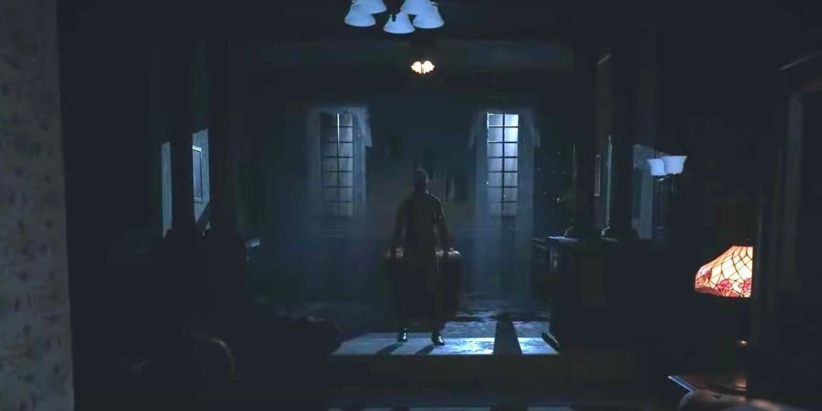 Мужчина стоит в темной комнате