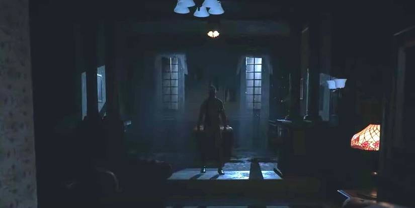 A man stands in a dark room